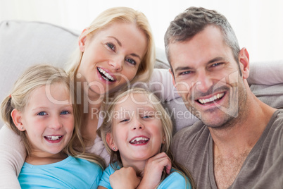 Portrait of parents and twins sitting on a couch