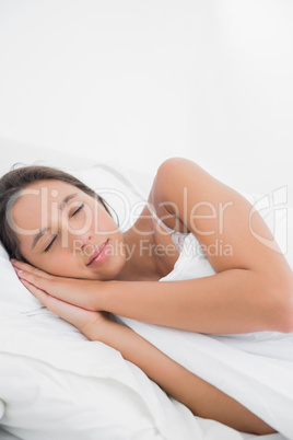 Peaceful woman sleeping in bed