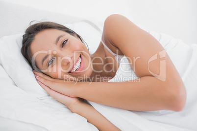 Pretty woman resting in bed
