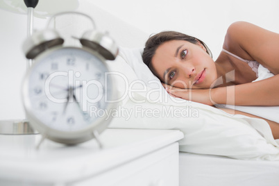 Woman waking up early in bed