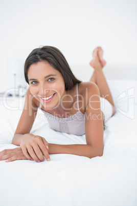 Portrait of a woman relaxing lying in bed