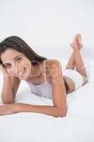 Attractive woman relaxing lying in bed