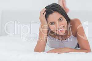 Portrait of a beautiful woman relaxing lying in bed