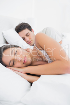 Woman sleeping next to her partner
