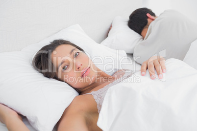 Thoughtful woman sleeping in bed