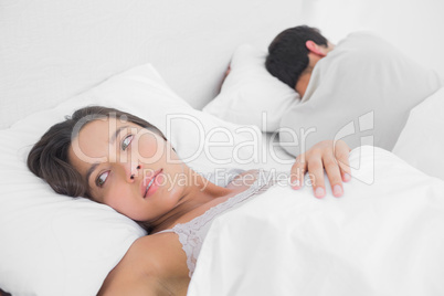 Anxious woman sleeping in bed