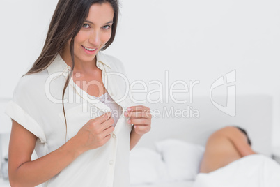 Woman sneaking out of bed