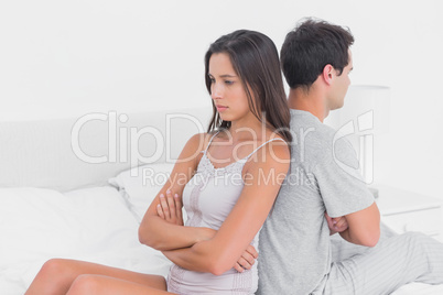 Unhappy couple ignoring each other sitting back to back