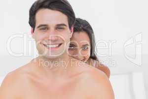 Woman hiding behind shirtless partner