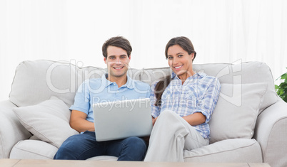 Couple relaxing with a laptop