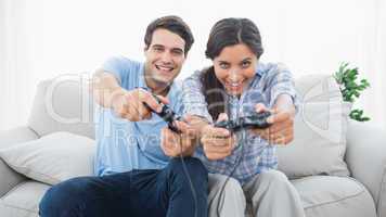 Couple playing video games on the couch