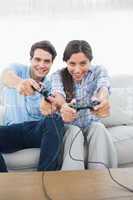 Portrait of a couple playing video games on the couch