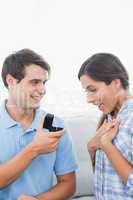 Handsome man offering an engagement ring to his girlfriend