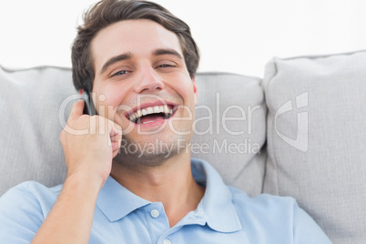 Man laughing while having a phone conversation