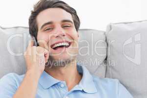 Man laughing while having a phone conversation