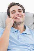 Man laughing while being on the phone