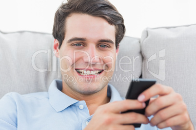 Portrait of a man text messaging with his phone