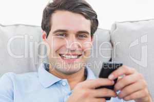 Portrait of a man text messaging with his phone