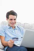 Man using his credit card to buy online