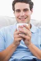 Portrait of a man holding a cup of coffee