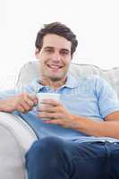 Portrait of a smiling man holding a cup of coffee