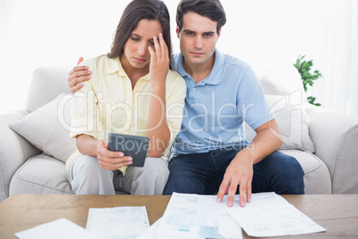 Anxious couple doing their accounts