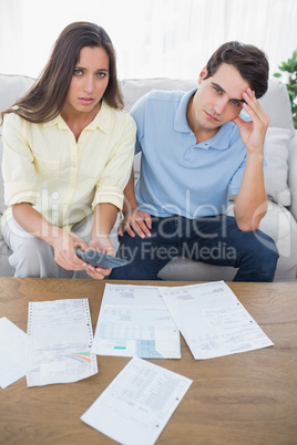 Concerned couple doing their accounts