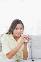 Portrait of a pretty woman holding a cup of coffee