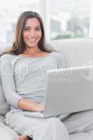 Portrait of a woman relaxing and using her laptop