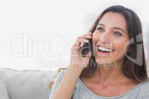 Woman laughing while she is on the phone