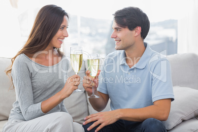 Lovers clinking their flutes of champagne