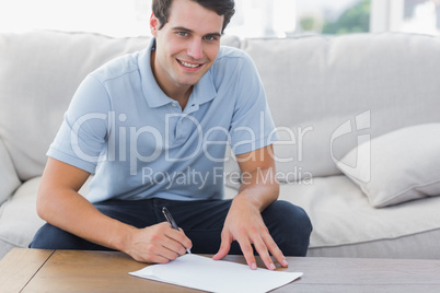 Portrait of a man writing on a paper