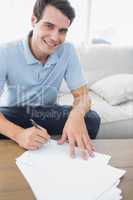 Portrait of a handsome man writing on a paper