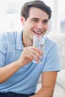Cheerful man holding a glass of water