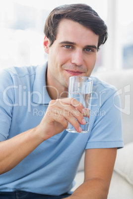 Portrait of a man holding a glass of water