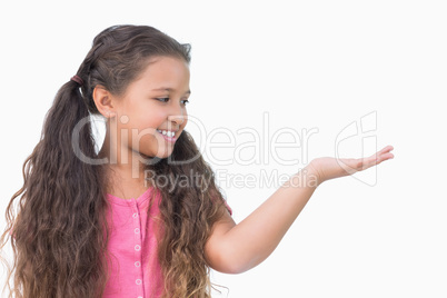 Smiling little girl presenting something