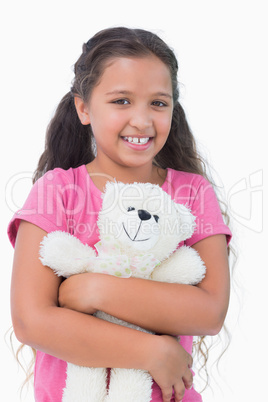 Cute little girl holding her teddy bear