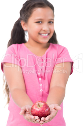 Little girl holding apple in her hands