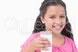 Smiling little girl drinking milk
