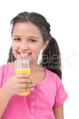 Happy little girl drinking orange juice