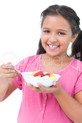 Little girl eating fruit salad