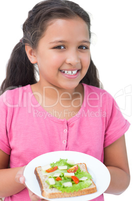 Little girl showing her sandwich to camera