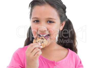 Cute little girl eating a cookie