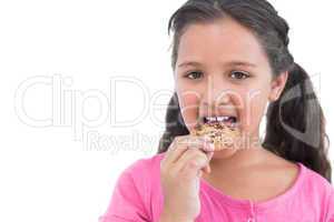 Happy little girl eating a cookie