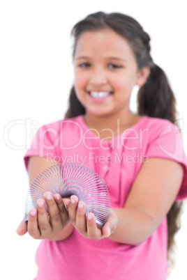 Little girl showing spring in her hands to camera