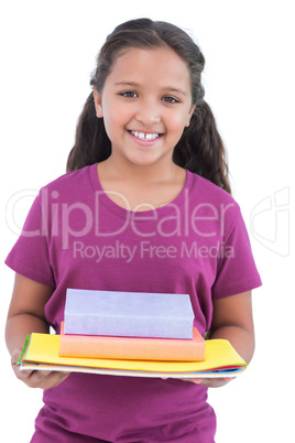 Little girl holding notebooks and books for her homework