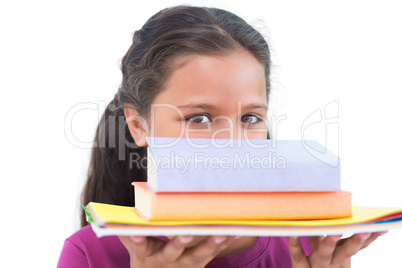 Little girl holding her homework and looking at camera