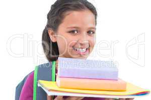 Little girl wearing book bag and holding her homework