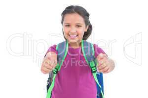 Smiling little girl with book bag does thumbs up at camera