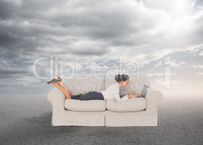 Elegant businesswoman lying on couch